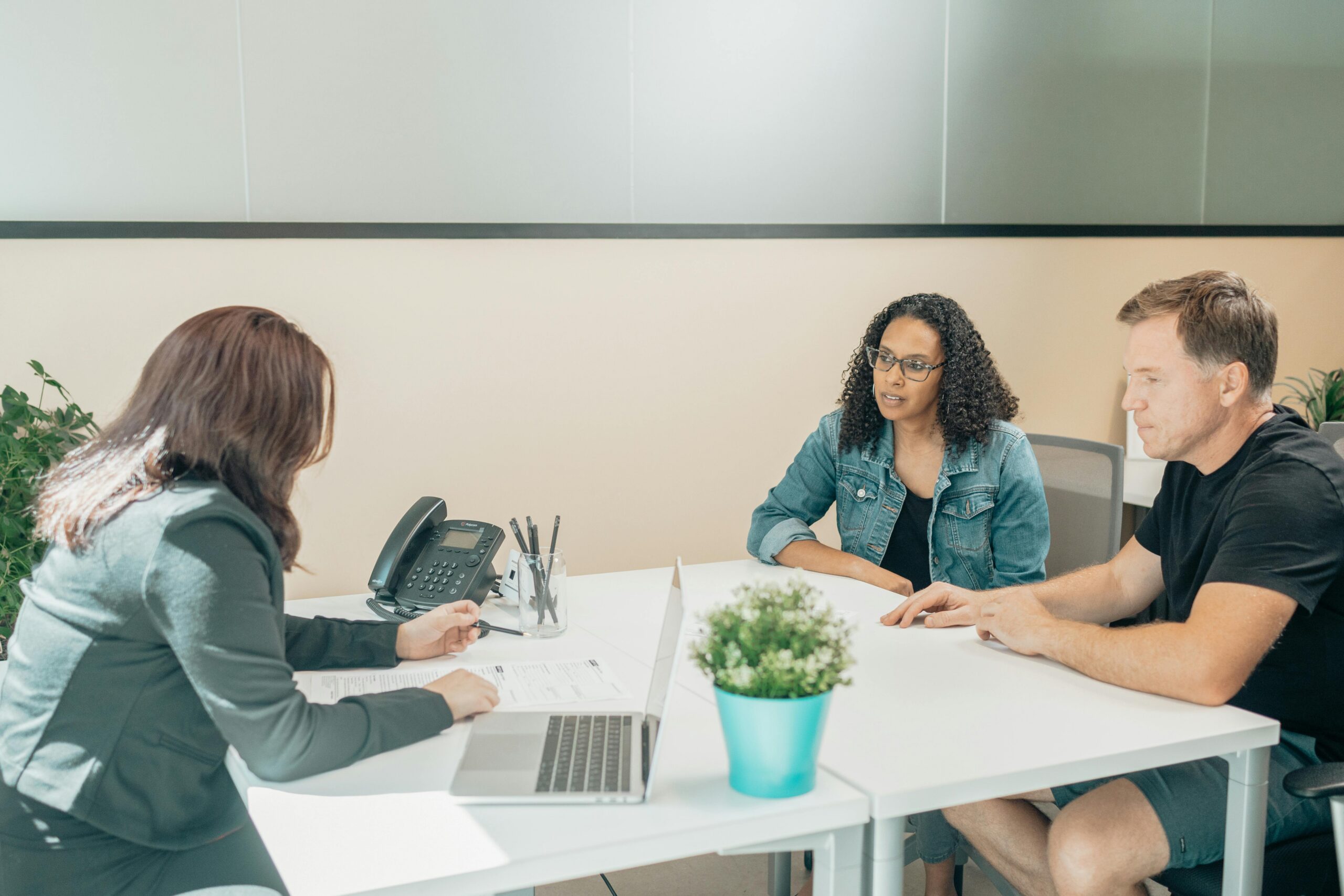 Three people having a meeting.